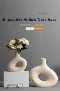 Close-up of minimalist ceramic vase with hollow ring design and matte white finish texture