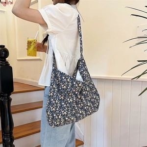 Detail showing high-capacity floral canvas tote bag on model for casual daily use