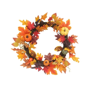 Autumn wreath with maple leaves, pumpkins and berries for festive wall decoration