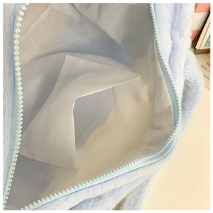 Detail view of the plush cat bag interior featuring a white fabric lining and inner pocket