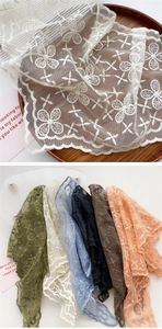 Detail of embroidered floral lace scarf in multiple colors with fine clover patterns