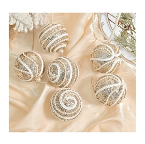 Detail of luxury champagne gold Christmas balls with sequins on silk fabric background