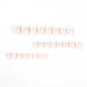 Short square press-on nails with nude base, white French tips and gold glitter lines