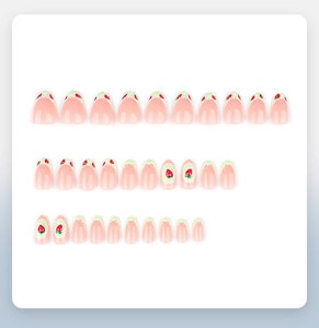 Flat lay detail of strawberry press-on nails with almond shape and lace patterns