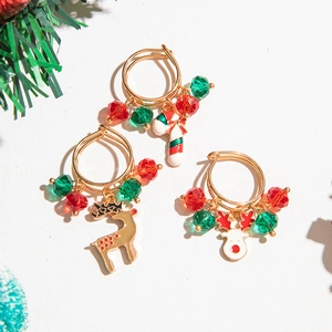 Detailed top view of Christmas earring set with elk and candy cane charms on white background