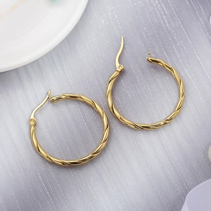 Polished 30mm golden twisted hoop earrings in minimalist stainless steel for women