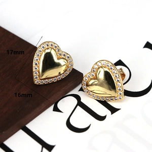 Detail view of 17mm gold heart earrings with white cubic zirconia inlay and size specs