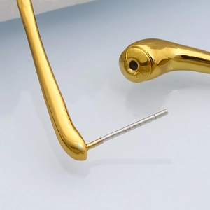 Detailed macro view of S925 sterling silver needles on gold teardrop drop earrings