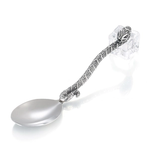 Vintage stainless steel spoon with creative snake pattern handle on ice block base