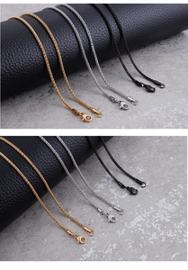 Detailed view of 2mm stainless steel corn chains in gold, silver, and black with lobster clasps