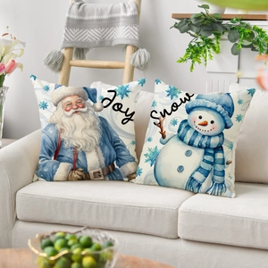Christmas pillow covers featuring watercolor Santa and Snowman on a beige sofa
