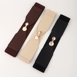 Three elastic waist belts in brown, beige, and black with round gold metal buckles