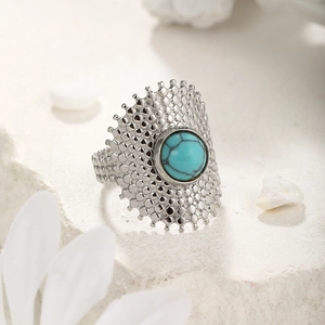 Bohemian silver ring with turquoise stone and dotted texture on natural stone base