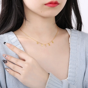 Elegant gold star and moon necklace with sparkling rhinestones on model's neck