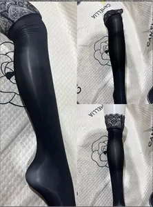 Close-up of black lace top thigh-high stockings with oily sheen and silicone anti-slip band