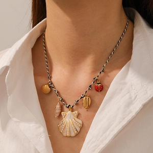 Detail of woven rope necklace with starfish shell charms and small ladybug pendant