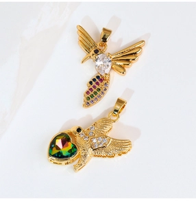 Macro shot of gold hummingbird pendants with colorful gemstones for DIY jewelry crafts