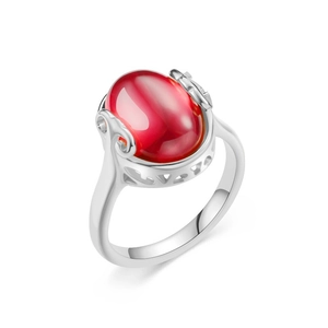 Detail of vintage silver titanium ring featuring a large oval red ruby and filigree scrollwork