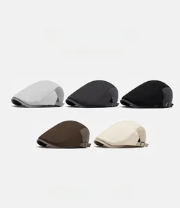 Detail of adjustable metal buckles and twill texture on newsboy caps in five colors