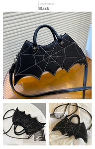Detail of bat-shaped handbag featuring white spiderweb stitching and cross zipper puller