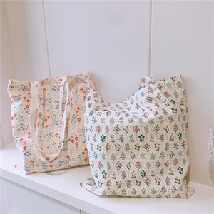 Detailed view of floral cotton canvas tote bags with elegant botanical prints and patches