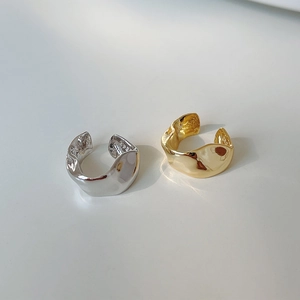 Close-up of S925 silver ear cuffs with irregular textures in gold and silver finish