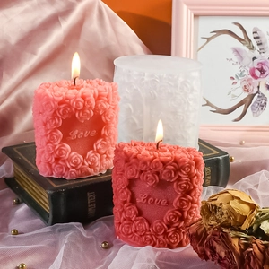 Close-up of silicone heart rose candle mold with Love embossed texture and finished samples