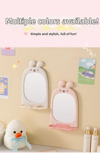 Detail of cute rabbit-shaped wall mirrors with small storage shelves in pink and white