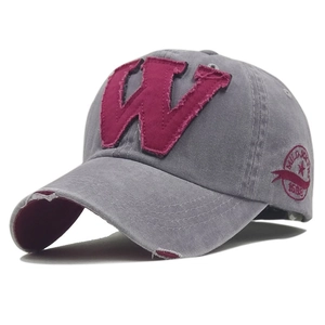 Detailed embroidery of letter W and Mild Joker logo on distressed grey baseball cap