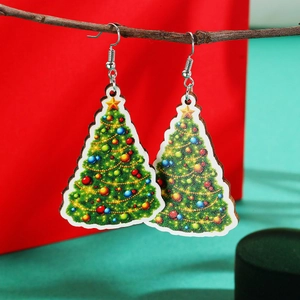 Close-up of green Christmas tree earrings with colorful ornaments on a branch