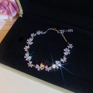 Detailed view of shimmering zircon butterfly bracelet on black velvet gift box