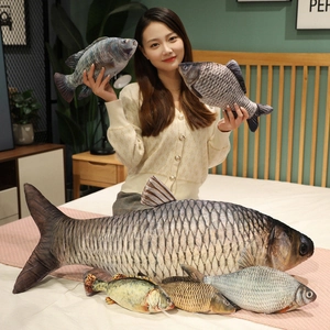 Detail of diverse realistic fish plush pillows in multiple sizes for home decoration