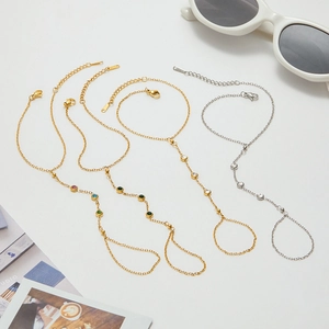 Detailed flat lay of gold and silver bracelets with colorful gemstones and jewelry props