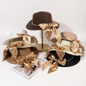 Flat top straw sun hats for women with elegant pearl bands and large satin bows