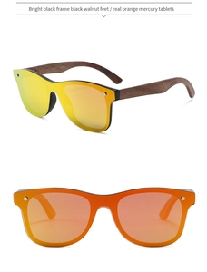 Detail of bamboo wood sunglasses with orange mirror lenses and black walnut temples