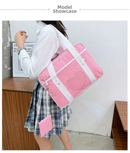 Detailed view of pink Japanese JK school bag with heart window and white woven strap
