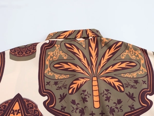 Detailed view of shirt back collar featuring brown and orange palm tree geometric patterns