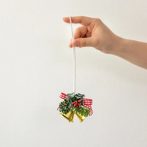 Golden Christmas bell hanging ornament with pine cones, berries and red plaid bow