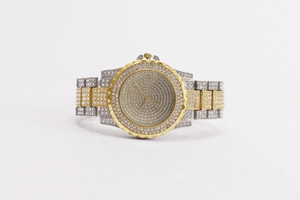 Detailed macro view of gold and silver quartz watch fully paved with shimmering crystals