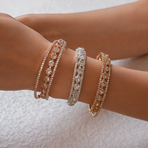 Detailed view of triple-layered cuff bracelets in rose gold and silver with zircon pave