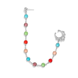 Detail of silver chain nose-to-ear piercing jewelry with vibrant multi-colored gemstones