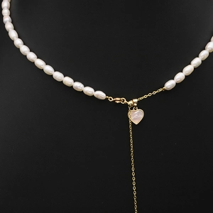 Elegant white freshwater pearl necklace featuring a golden chain and heart-shaped pendant