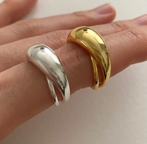Close-up of minimalist gold and silver 925 sterling silver rings with thick curved design