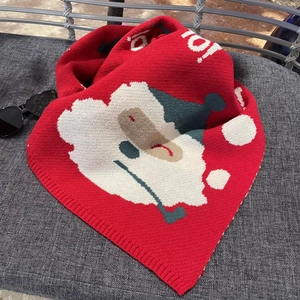 Close-up of red Christmas knit scarf with white Ho Ho Ho festive patterns and textures
