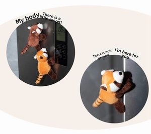 Cute plush red panda fridge magnets in brown and orange colors on black metal surface