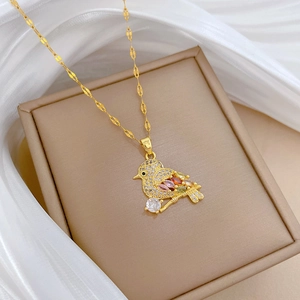 Macro shot of bird pendant necklace with sparkling micro-pave zircons and colorful gems