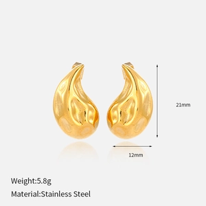 Detailed view of golden teardrop earrings in stainless steel with a wavy texture finish