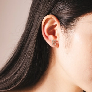 Close-up of S925 sterling silver number 5 stud earring with sparkling pavé crystals on ear