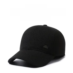 Detailed macro view of the mountain shaped metal logo on the black winter baseball cap