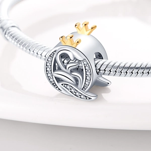 Detailed view of silver swan charm with gold crowns and crystals on snake chain